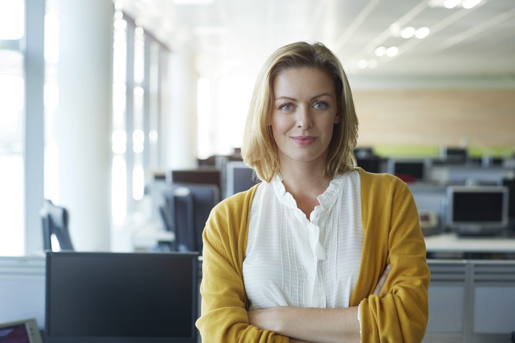 Portrait of a businesswoman standing with her arms folded in the office